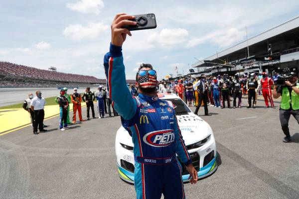 Driver Bubba Wallace takes a selfie with himself and other drivers that pushed his car to the f ...