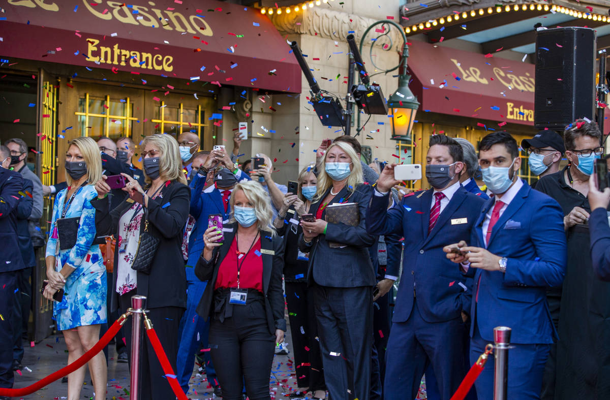 Paris Las Vegas staff look on as confetti rains down during a reopening celebration following t ...