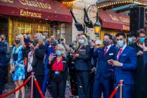 Paris Las Vegas staff look on as confetti rains down during a reopening celebration following t ...