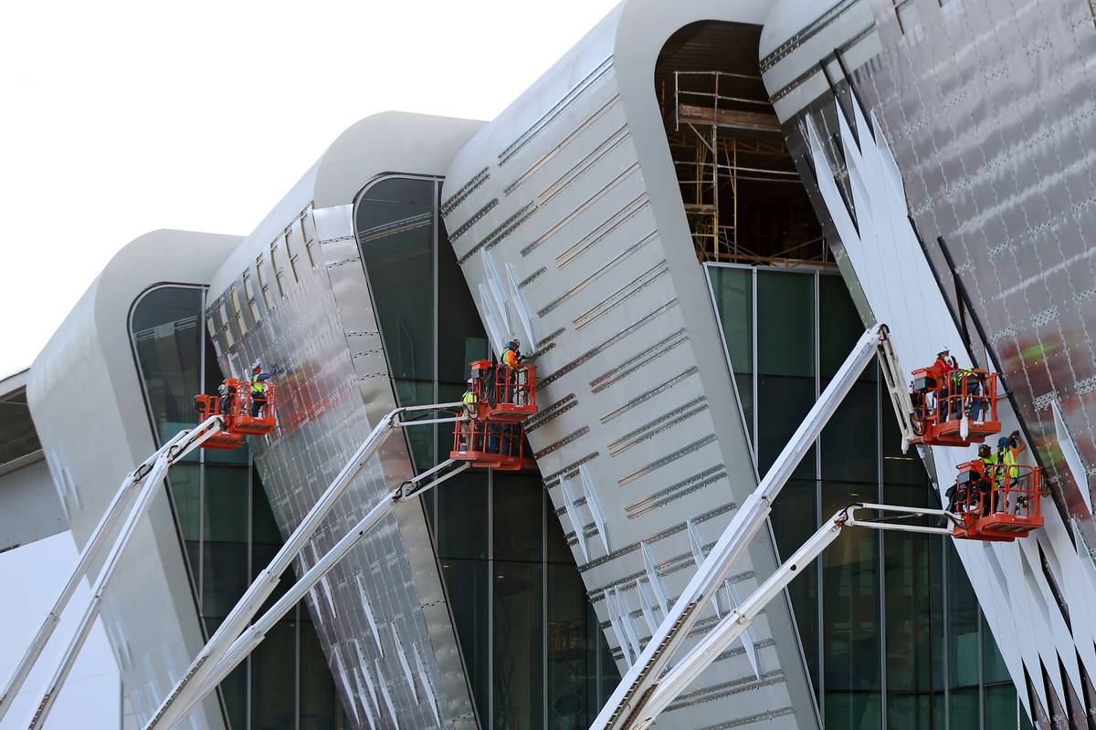 Workers finish the exterior walls on the west side of the Las Vegas Convention Center expansion ...