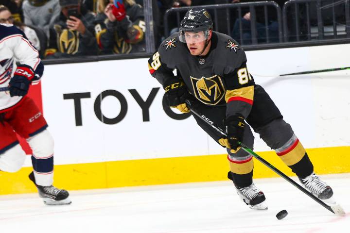 Golden Knights' Nate Schmidt (88) skates with the puck in front of Columbus Blue Jackets' Emil ...