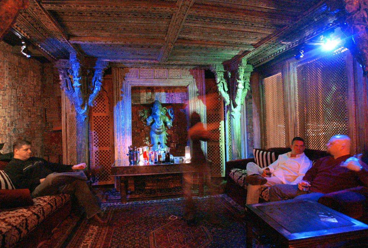 A group from Boston mingles while enjoying cocktails in the Ganesh room, a private room in the ...