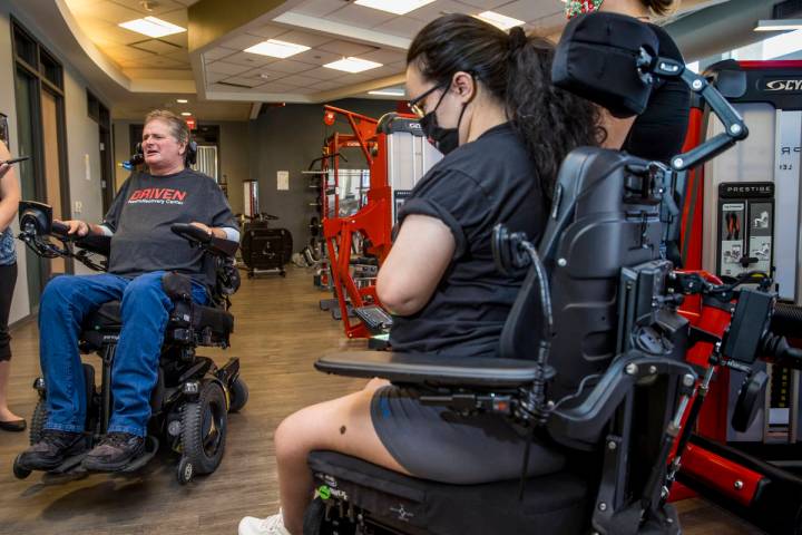 Quadriplegic IndyCar team owner Sam Schmidt, left, talks about the upcoming free virtual workou ...