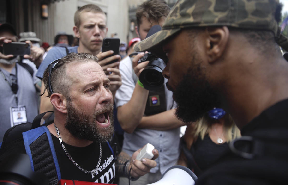 Scott Hilliard, left, argues with Black Lives Matter protester Eugene Smith ahead of President ...