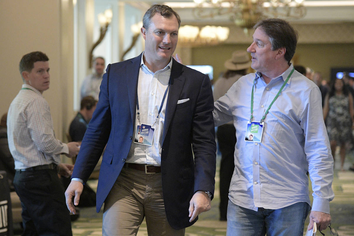 San Francisco 49ers general manager John Lynch chats with Don Banks, right, while walking to a ...