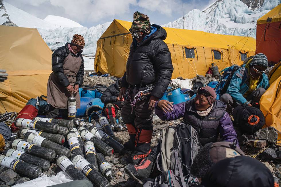Members of the expedition with gear and supplies in a scene from "Lost on Everest." ( ...
