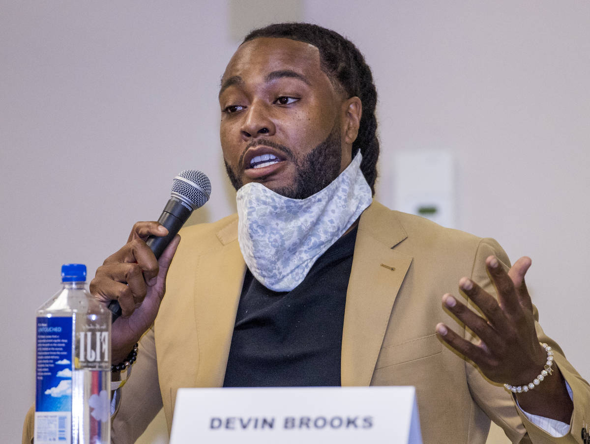 Panel member Devin Brooks speaks during a Solutions, Strategies & Service Summit related to ...