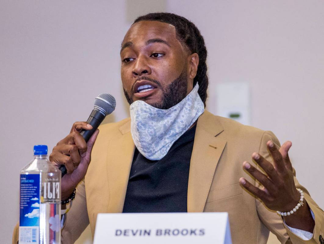 Panel member Devin Brooks speaks during a Solutions, Strategies & Service Summit related to ...