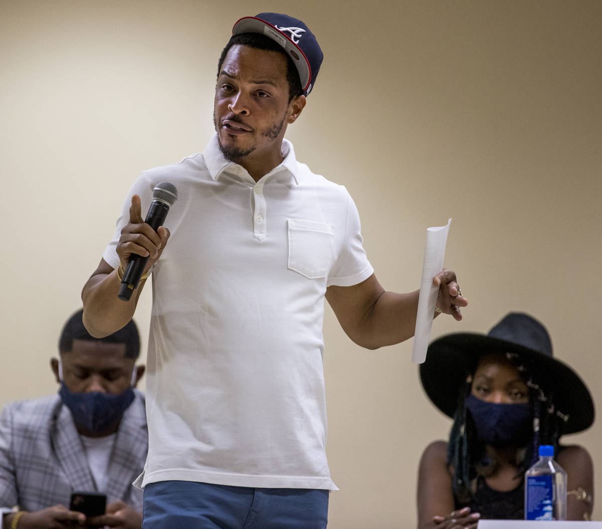 Rapper and entrepreneur Tip T.I. Harris, center, speaks while moderating a Solutions, Strategie ...