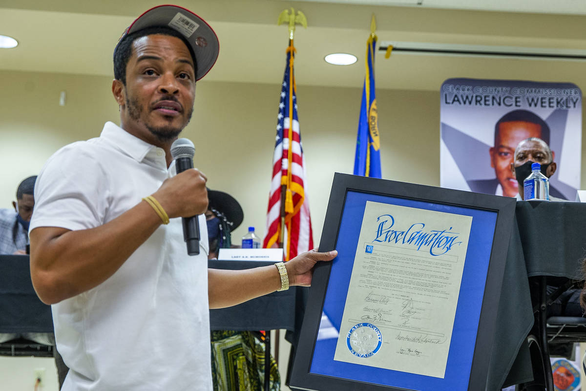 Rapper and entrepreneur Tip T.I. Harris, left, accepts a proclamation granting him today his da ...