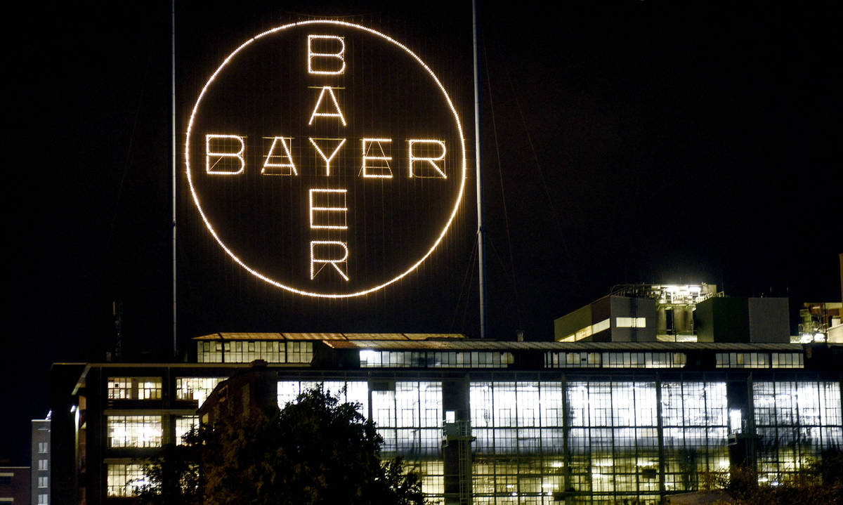 FILE - In this Aug. 9, 2019, file photo, the Bayer logo shines at night at the main chemical pl ...