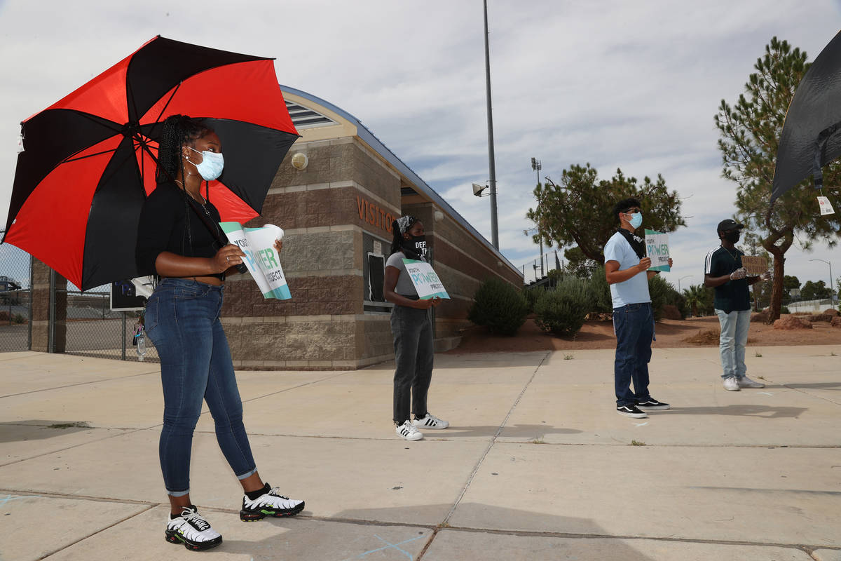 People attend a protest organized by Make The Road Nevada to demand the defunding of Clark Coun ...