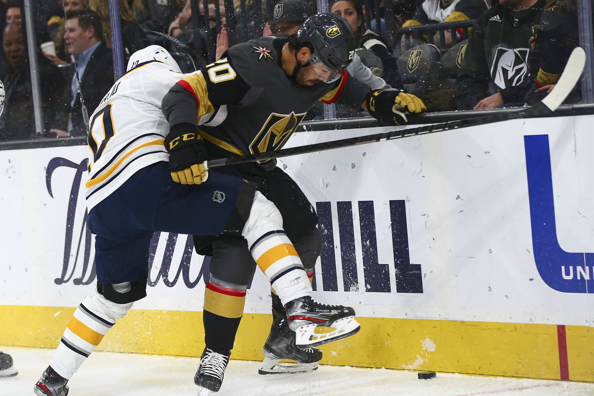 Buffalo Sabres' Henri Jokiharju (10) battles for the puck against Golden Knights' Chandler Step ...