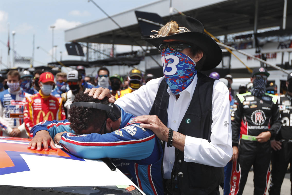 NASCAR driver Bubba Wallace is consoled by team owner Richard Petty, right, prior to the start ...
