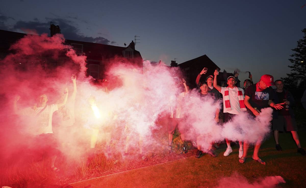 Liverpool supporters celebrates outside Anfield Stadium in Liverpool, England, Thursday, June 2 ...