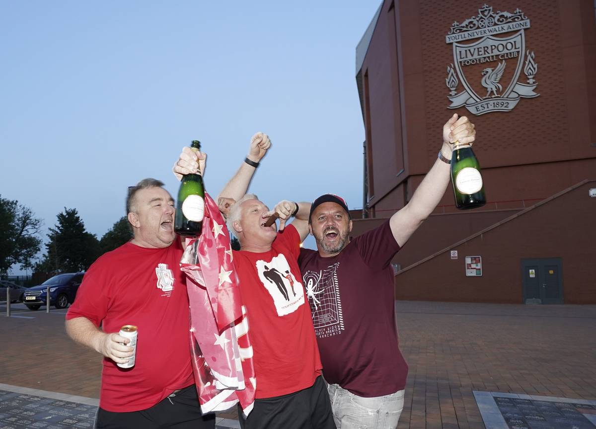 Liverpool supporters celebrate outside Anfield Stadium in Liverpool, England, Thursday, June 25 ...