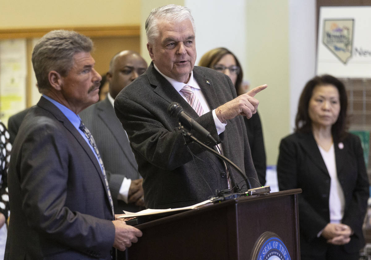 Richard Whitley, left, Department of Health and Human Services director, and Gov. Steve Sisolak ...