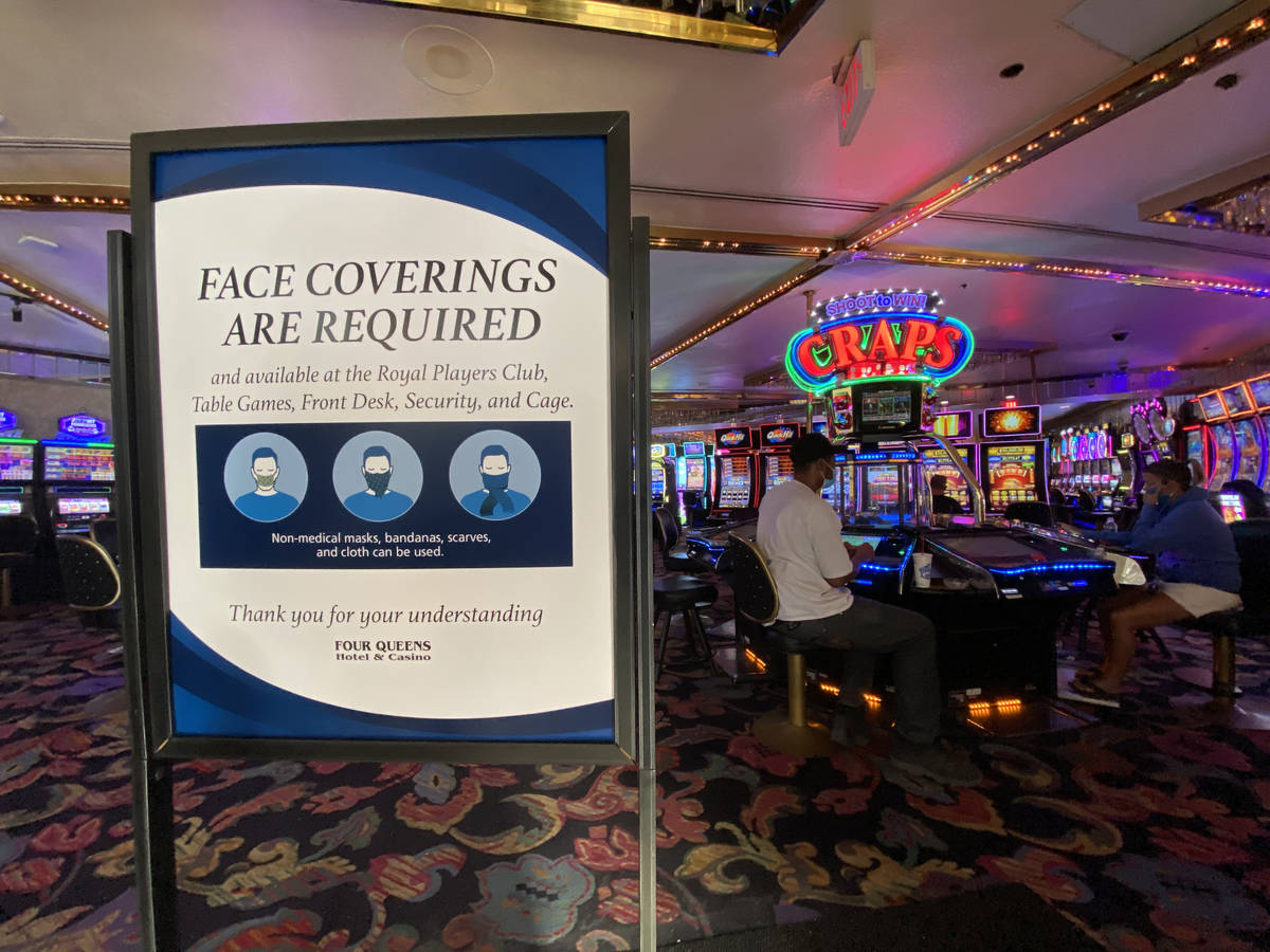 A sign notifying guests of a face covering requirement at Four Queens in downtown Las Vegas on ...