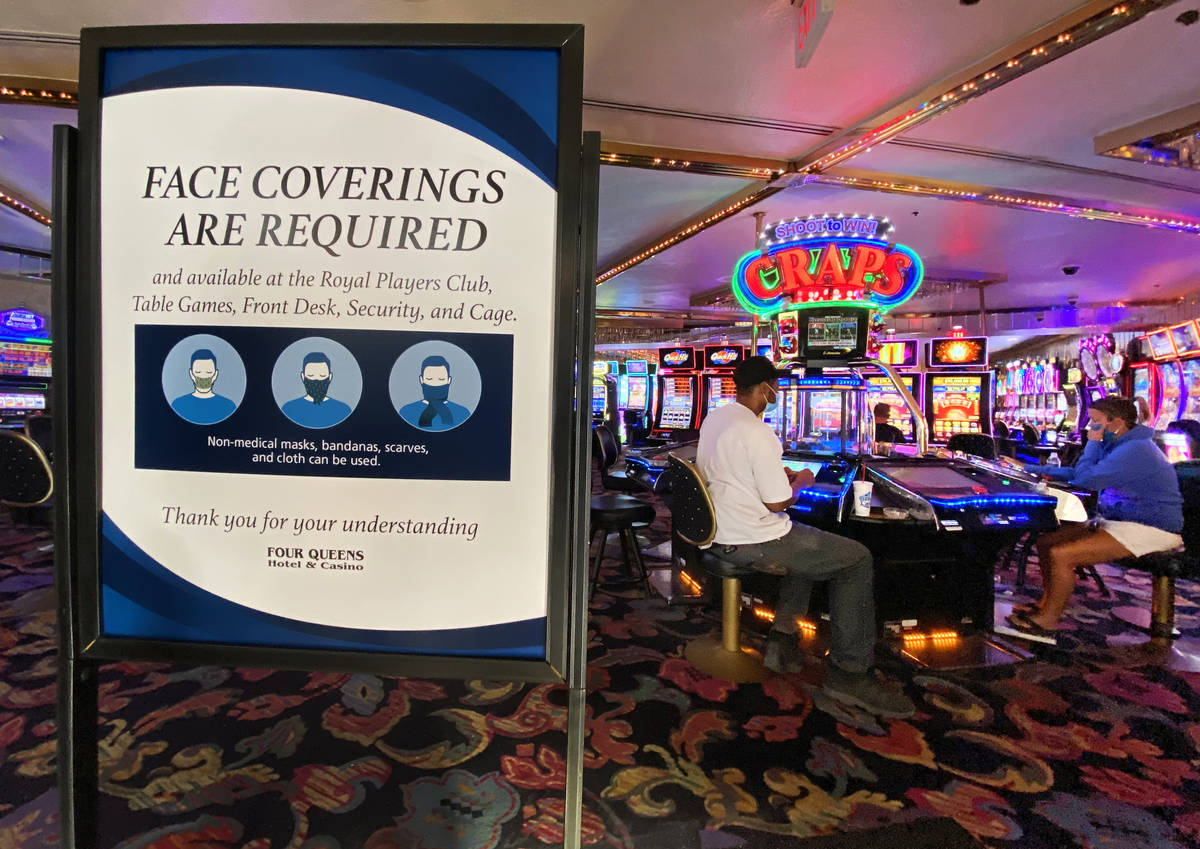 A sign notifying guests of face covering requirement at Four Queens in downtown Las Vegas Frida ...
