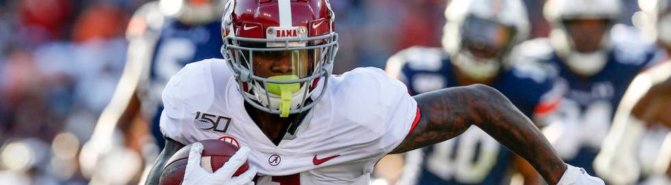 Alabama wide receiver Henry Ruggs III (11) carries the ball after a reception against Auburn du ...