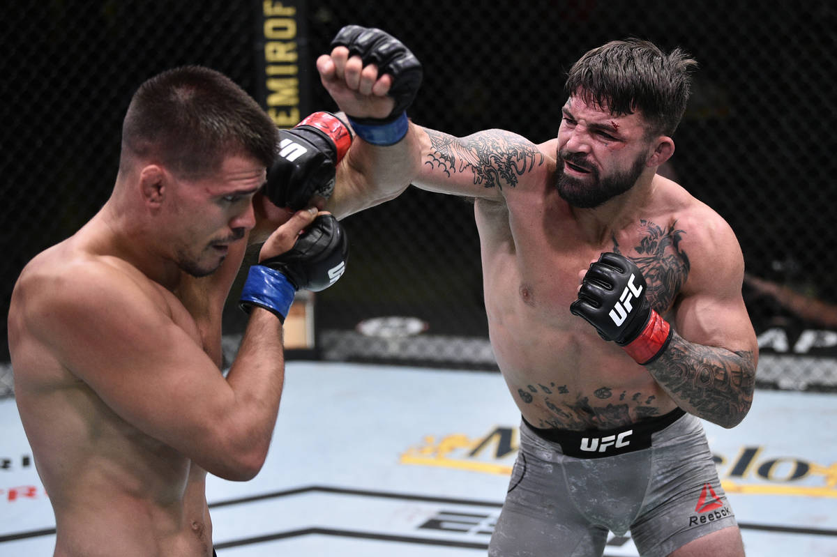 LAS VEGAS, NEVADA - JUNE 27: (R-L) Mike Perry punches Mickey Gall in their welterweight fight d ...