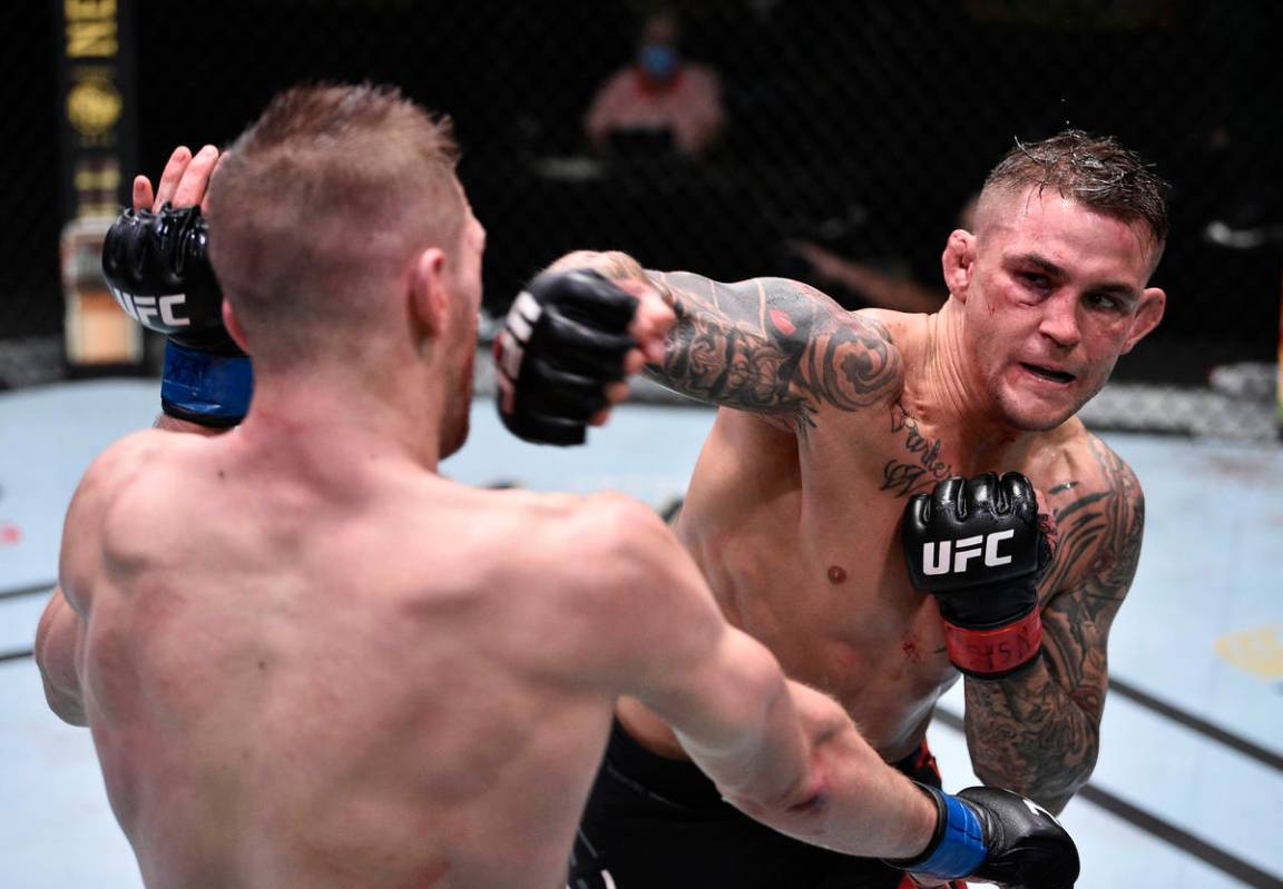 Dustin Poirier punches Dan Hooker of New Zealand in their lightweight fight during the UFC Figh ...