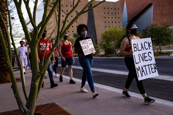 People participate in a silent solidarity march in support of Black Lives Matter and the Stonew ...