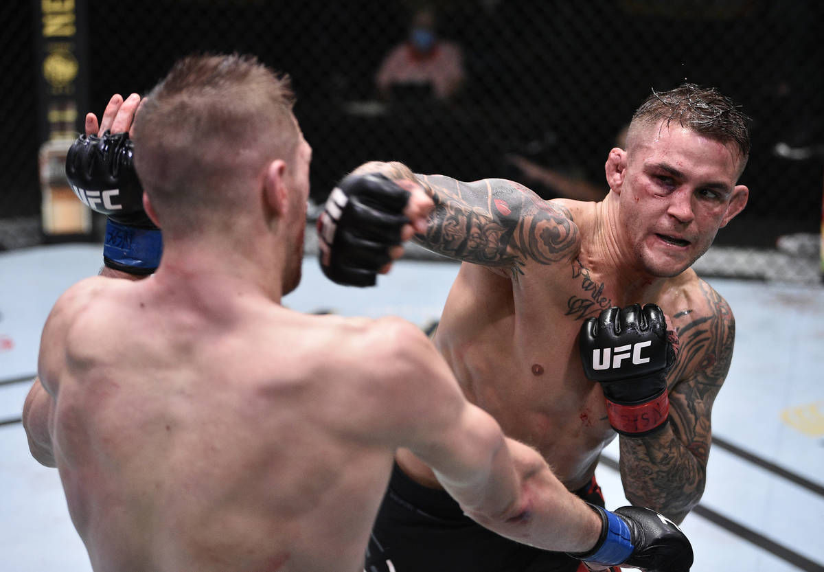 Dustin Poirier, right, punches Dan Hooker of New Zealand in their lightweight fight during the ...