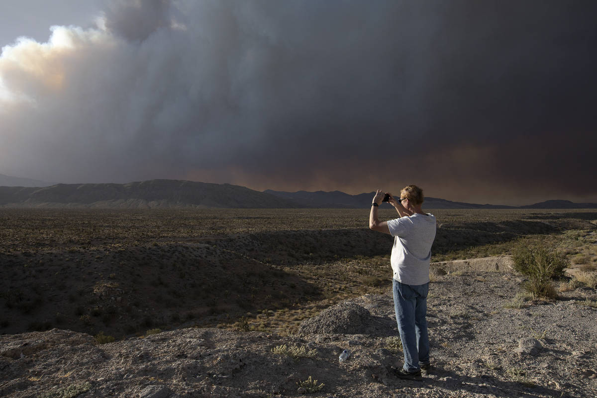 Chris Newcomer takes a photo of the Mahogany Fire on his way home from hiking Cathedral Rock at ...