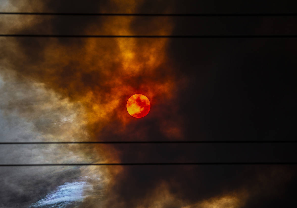 The sun is blanketed in red smoke originating from a wildfire at Mount Charleston on Sunday, Ju ...
