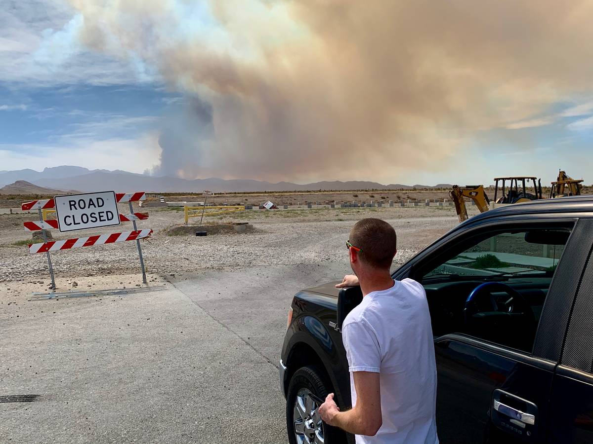 Nathan Taylor, a Las Vegas resident, watches smoke rising near Mount Charleston from West Grand ...