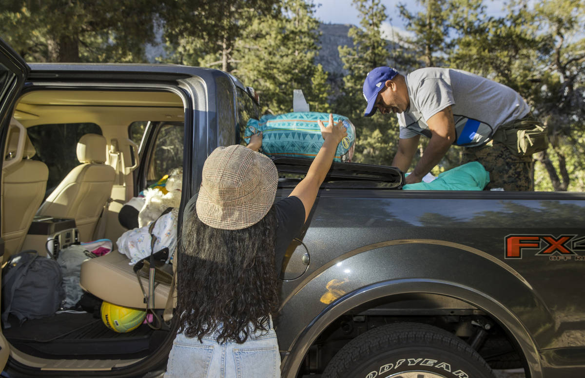 Isabel Nava, 17, left, and father Eddie Nava pack up their camping gear just to be safe as they ...