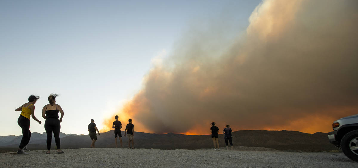 Onlookers stop to view the Mahogany Fire on Mount Charleston near a rise about Harris Spring Ro ...