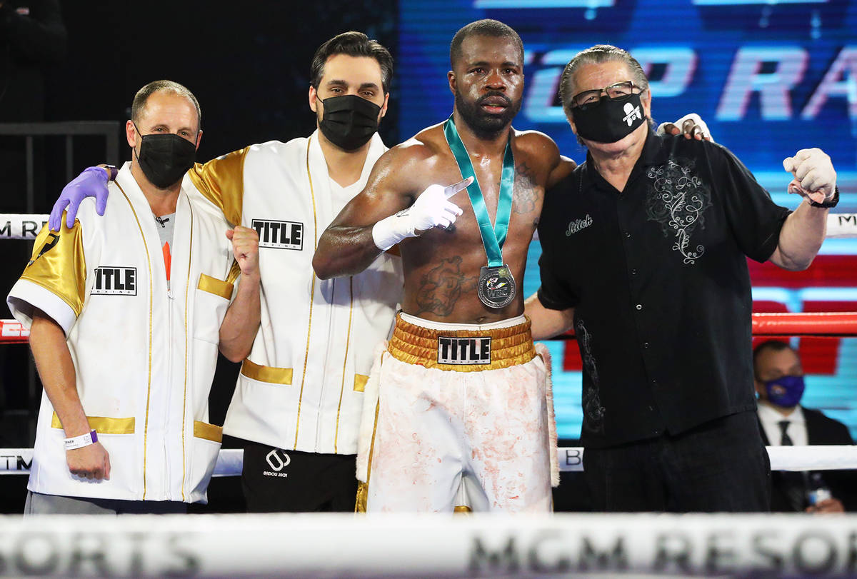 Boxer Quatavious Cash poses with cornermen, including cutman Jacob Duran (right) during a recen ...