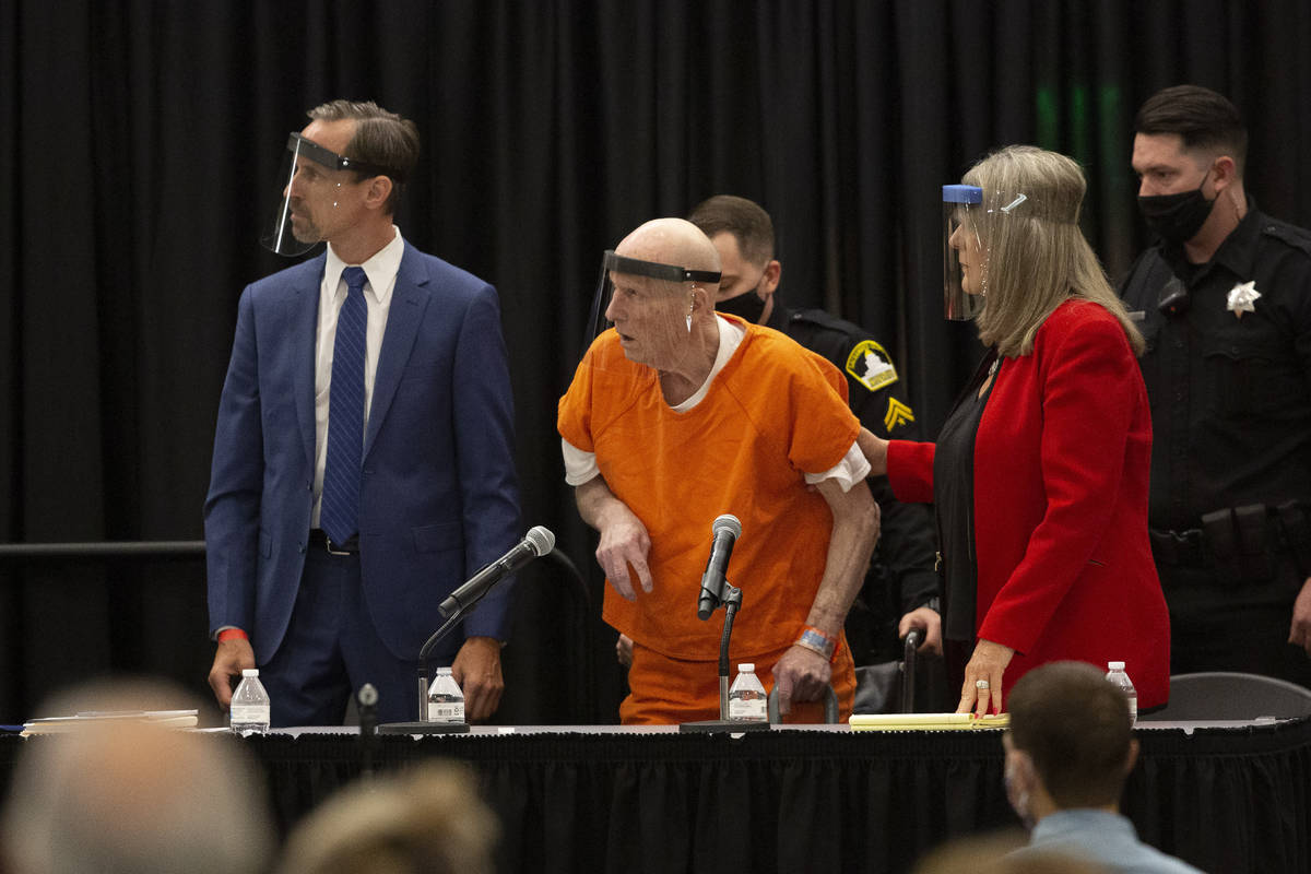 Joseph James DeAngelo, center, charged with being the Golden State Killer, his helped up by his ...