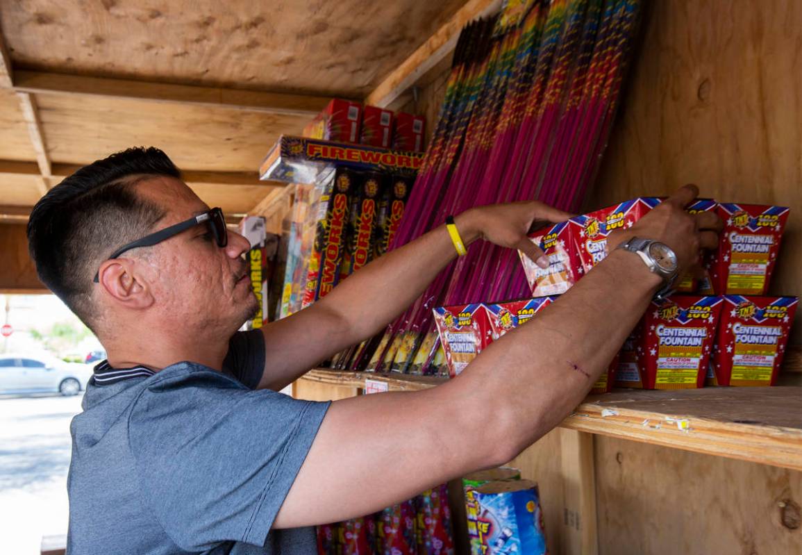 Floyd Ellis organizes fireworks on the top shelf of the fireworks booth for Freedom House Sober ...