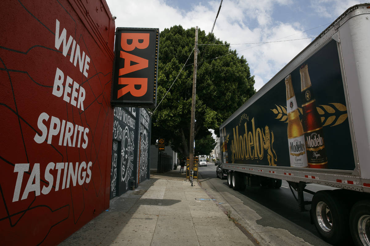 A truck with a beer advertisement stops in front of a bar in Los Angeles, Monday, June 29, 2020 ...