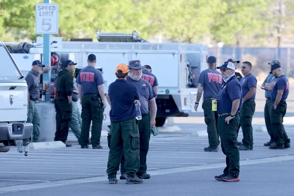 Firefighters from different agencies gather at Centennial High School in Las Vegas as they prep ...