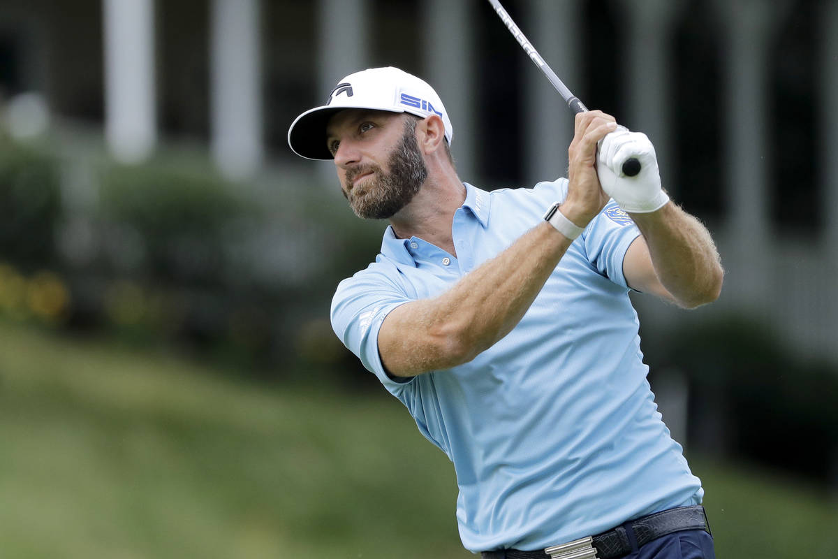 Dustin Johnson tees off on the 18th hole during the final round of the Travelers Championship g ...