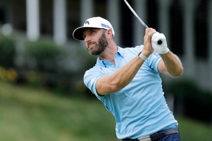 Dustin Johnson tees off on the 18th hole during the final round of the Travelers Championship g ...