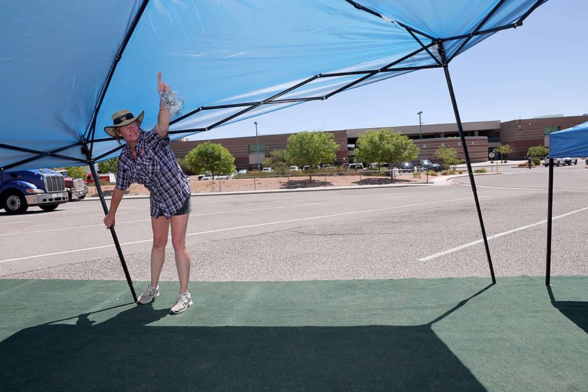 Leigha Smith of Ely, from Dewsnup Fire Support of Gridley, Calif., sets up shade structures and ...