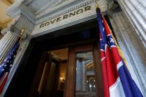 The Mississippi state flag is shown across from the American flag, outside the Governor's Offic ...