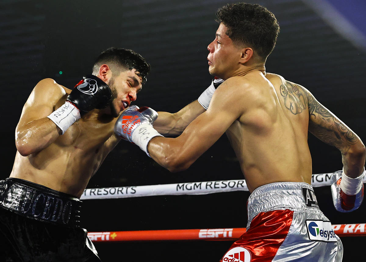 Junior welterweight Alex Saucedo makes contact against Sonny Fredrickson on Tuesday night at th ...