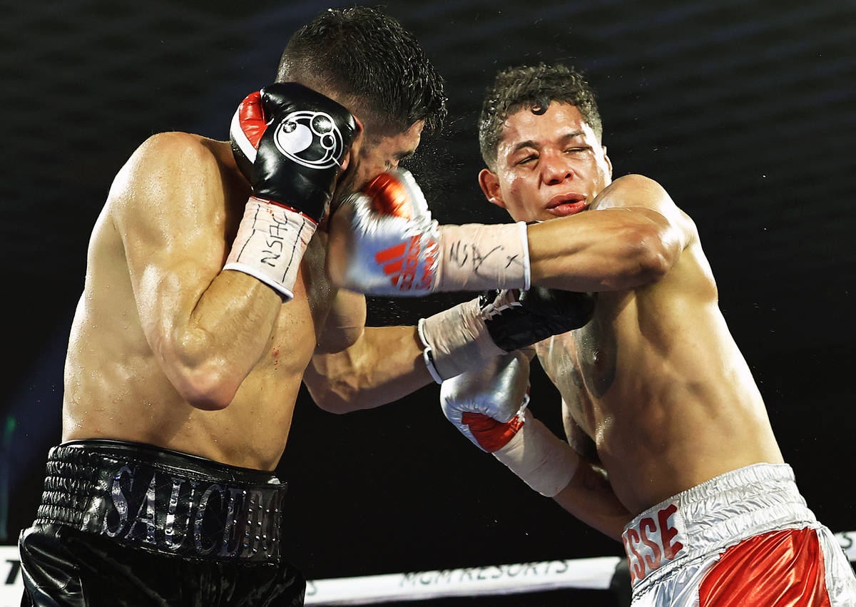 Junior welterweight Alex Saucedo takes a shot from Sonny Fredrickson on Tuesday night at the MG ...