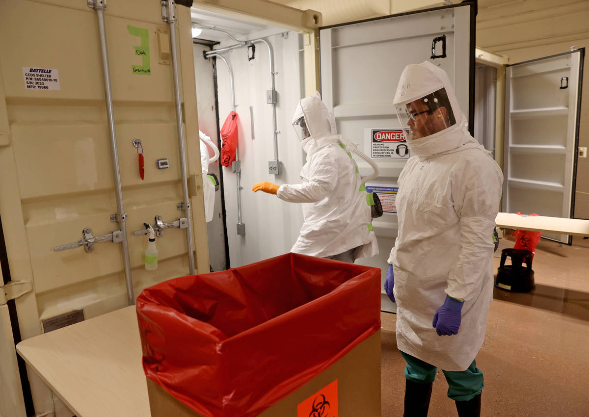 Workers prepare to decontaminate face masks at the Battelle Critical Care Decontamination Syste ...