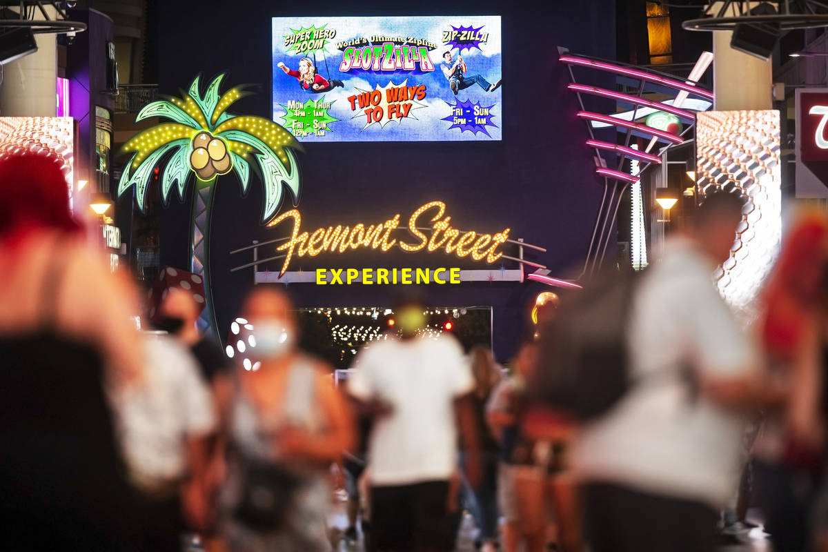 Visitors pack the Fremont Street Experience on Thursday, July 2, 2020, in Las Vegas. (Benjamin ...