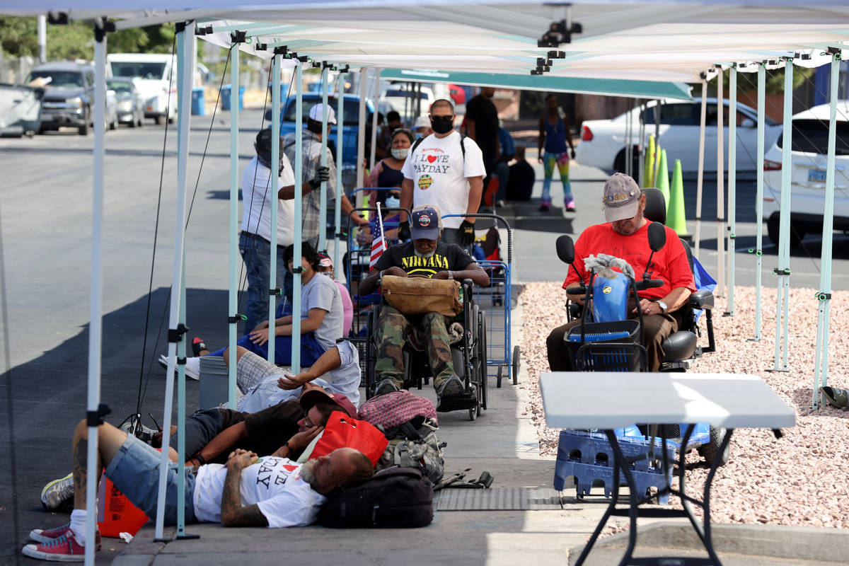 People line up for a food distribution at SHARE Village, formerly known as Veterans Village, in ...