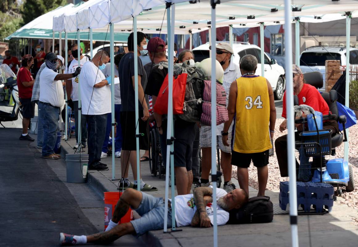 A volunteer registers people lined up for a food distribution at SHARE Village, formerly known ...