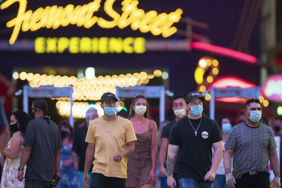 Visitors pack the Fremont Street Experience on Thursday, July 2, 2020, in Las Vegas. (Benjamin ...