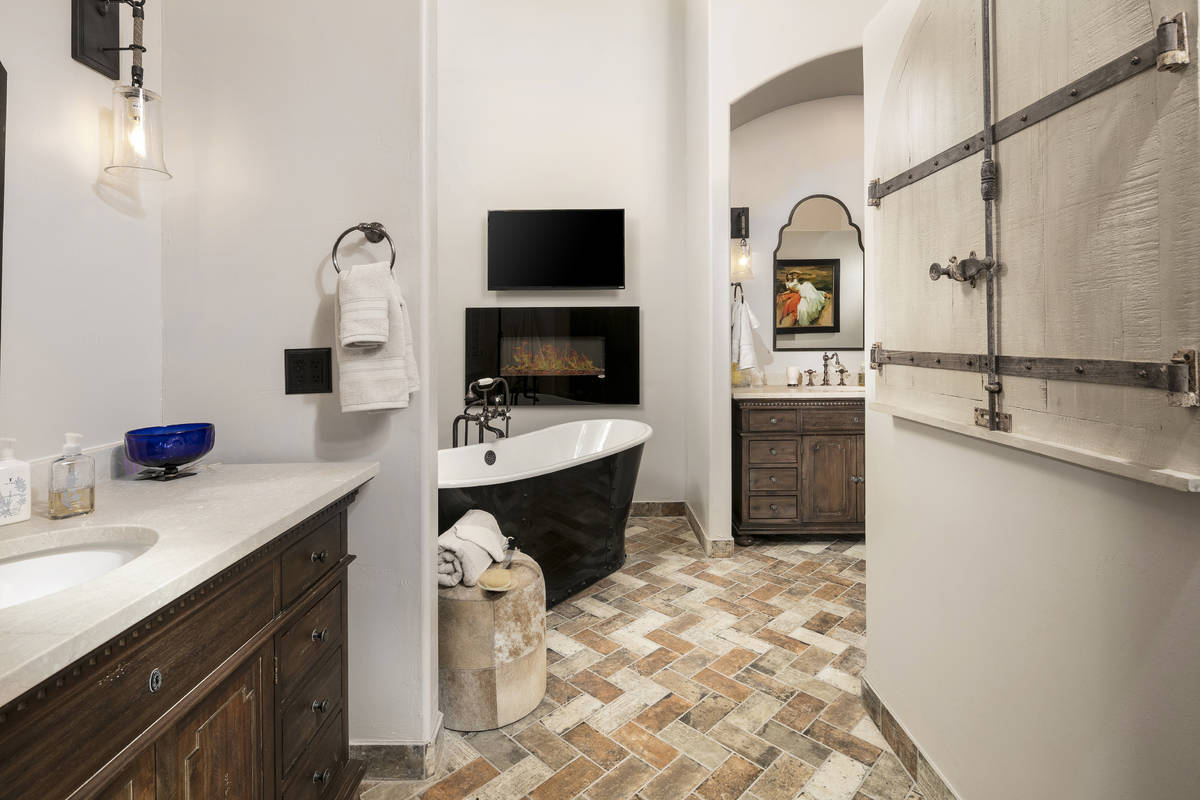 This bathroom's soaking tub and fireplace provide comfort and enhance overall well-being. (Room ...